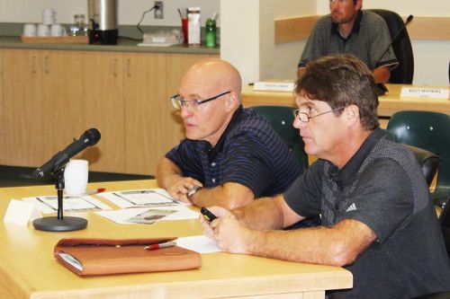 Chris Davis (l) and Greg Banks of the Bytown Motorcycle Association, outline their request for a one-day group access permit to North Frontenac Council. Photo/Craig Bakay